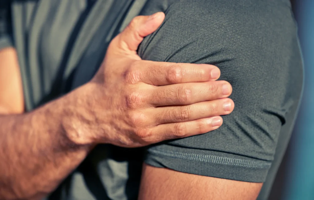 adult man experiencing shoulder pain in gray shirt 2026 03 25 06 44 33 utc