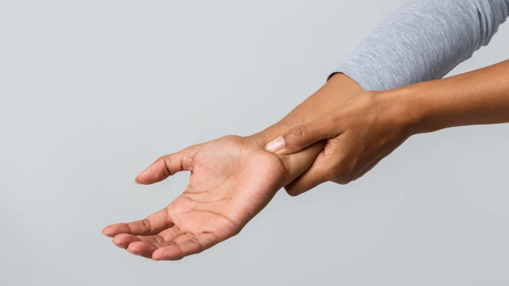 close up woman holding her wrist pain from using 2026 03 24 02 26 54 utc