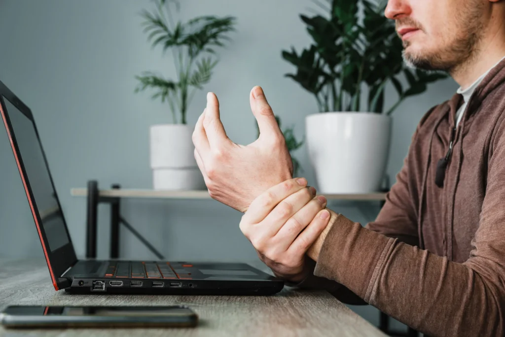 man with wrist pain at desk working 2026 03 09 03 45 27 utc