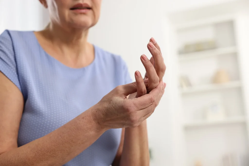 mature woman rubbing her sore hand indoors 2026 04 09 04 33 59 utc