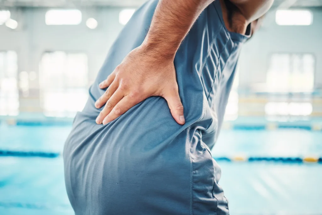 pain in back sports and man by swimming pool with 2026 03 25 02 22 05 utc