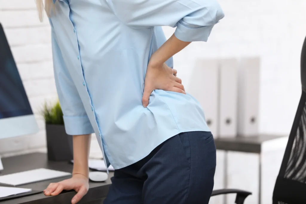 young woman suffering from back pain in office cl 2026 03 27 01 52 44 utc